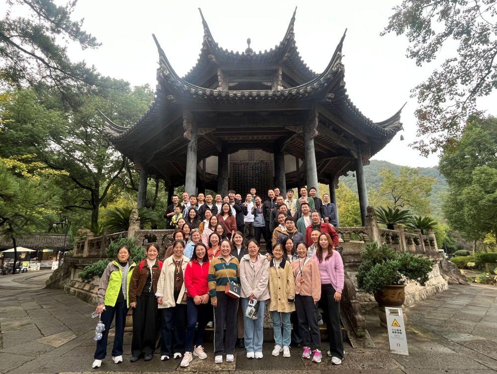 Group photo of the Sharehouse team under a pagoda roof